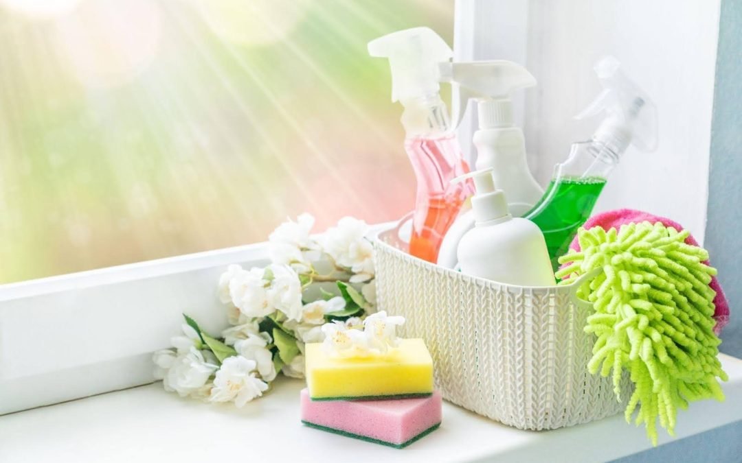A variety of colorful cleaning products arranged on a window sill 1080x675 1